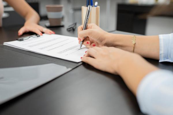 woman-s-hand-signing-employment-contract-2023-11-27-05-00-49-utc.jpg